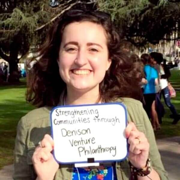 A student holding a Denison Venture Philanthropy sign